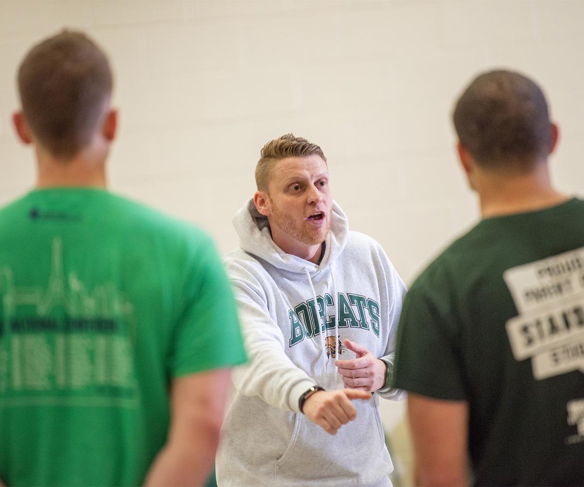 An instructor teaches students about coaching education.