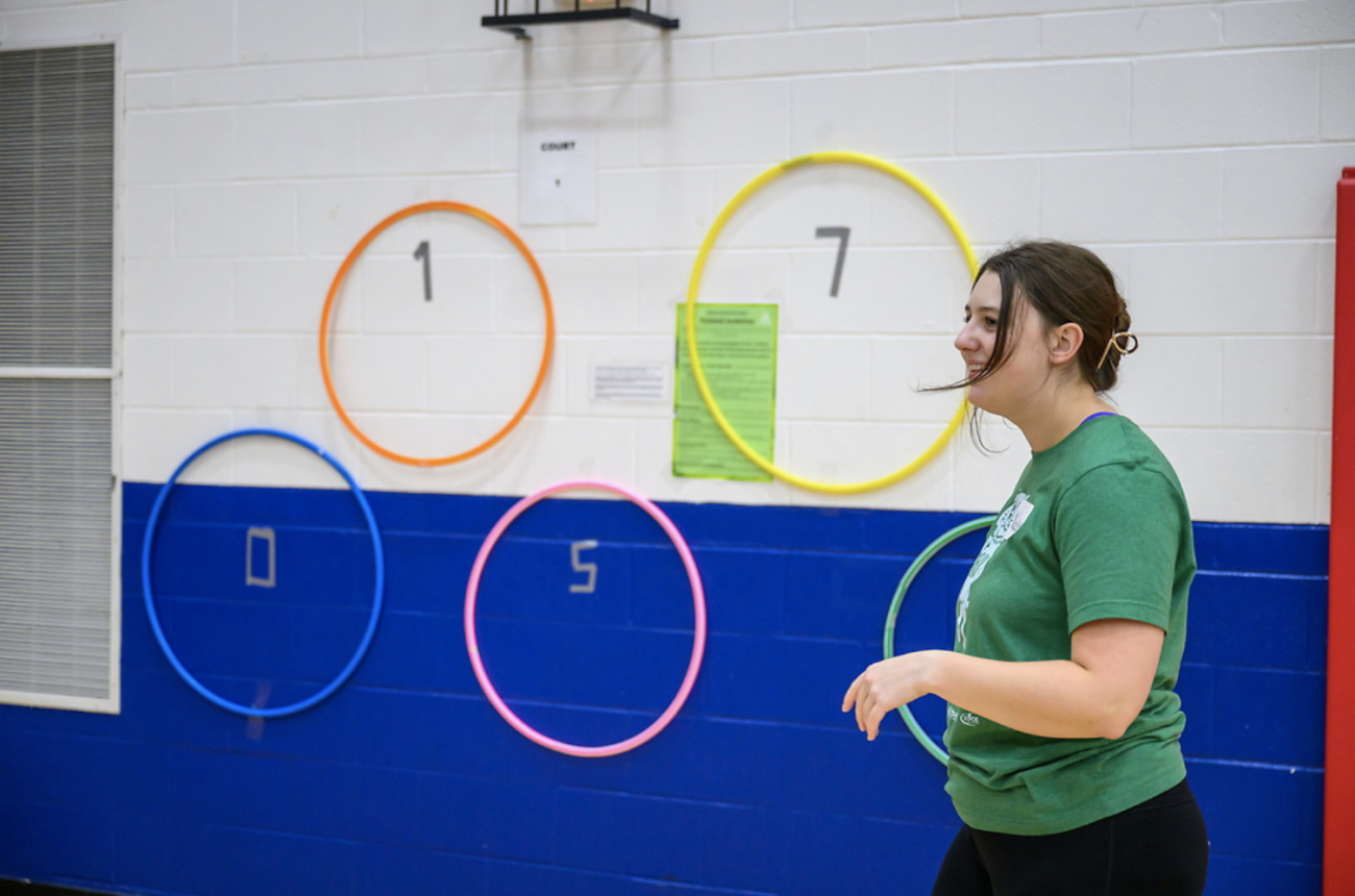 student instructing in gymnasium