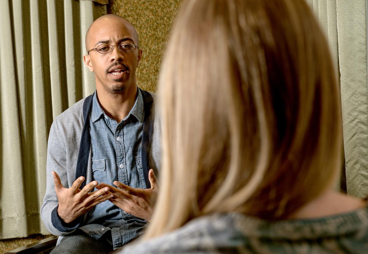 A counselor talks with a student in an office