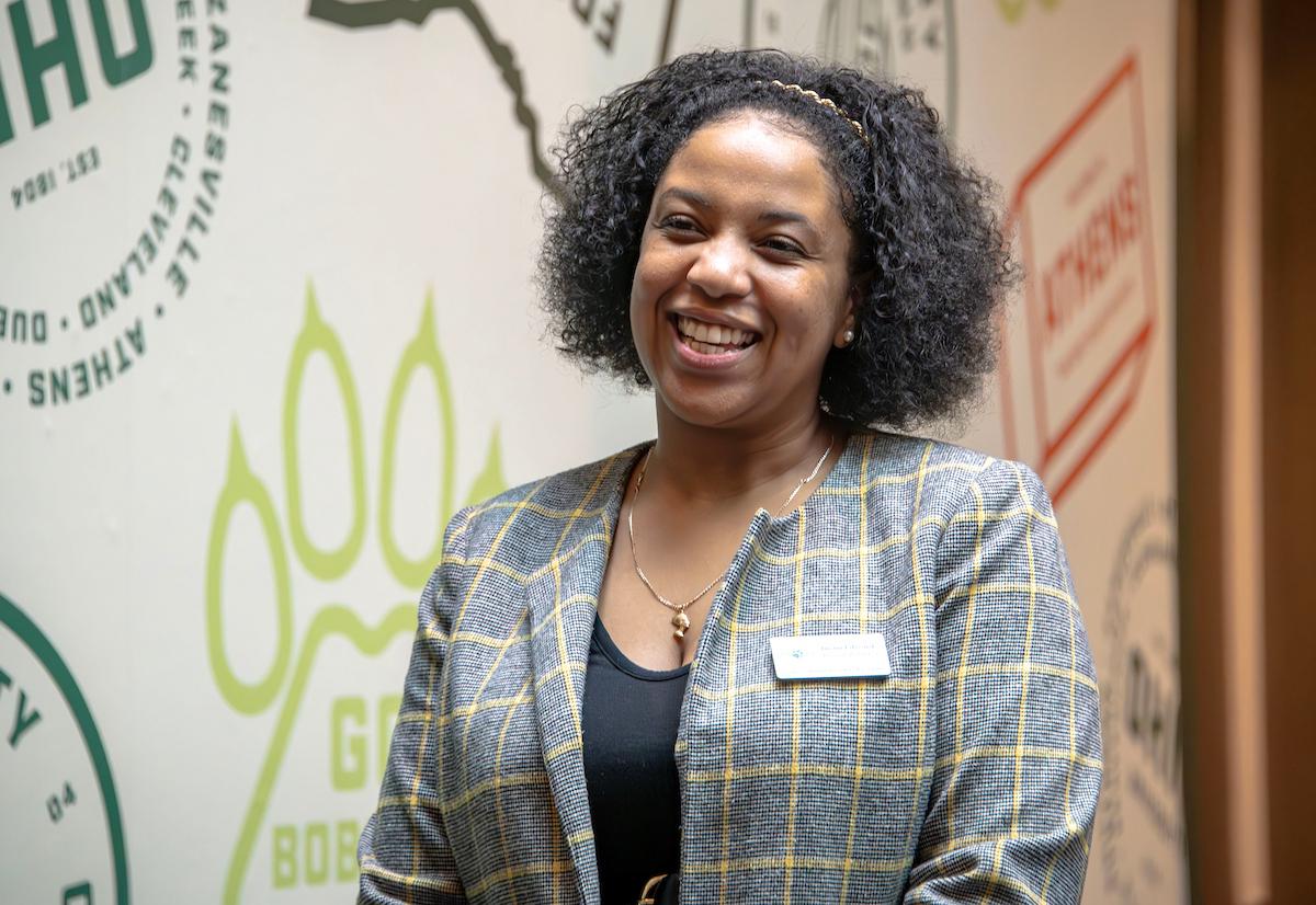 A woman wearing a suit smiles