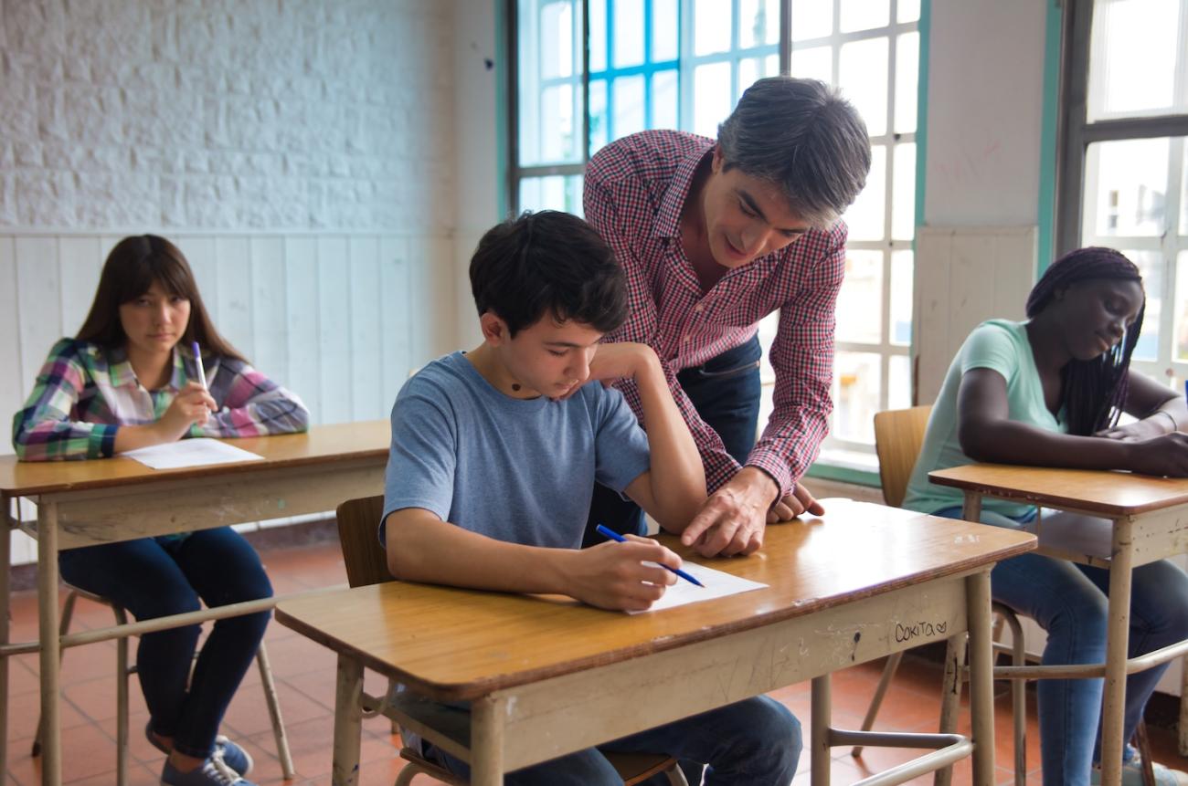 Teacher helping a student in a classroom