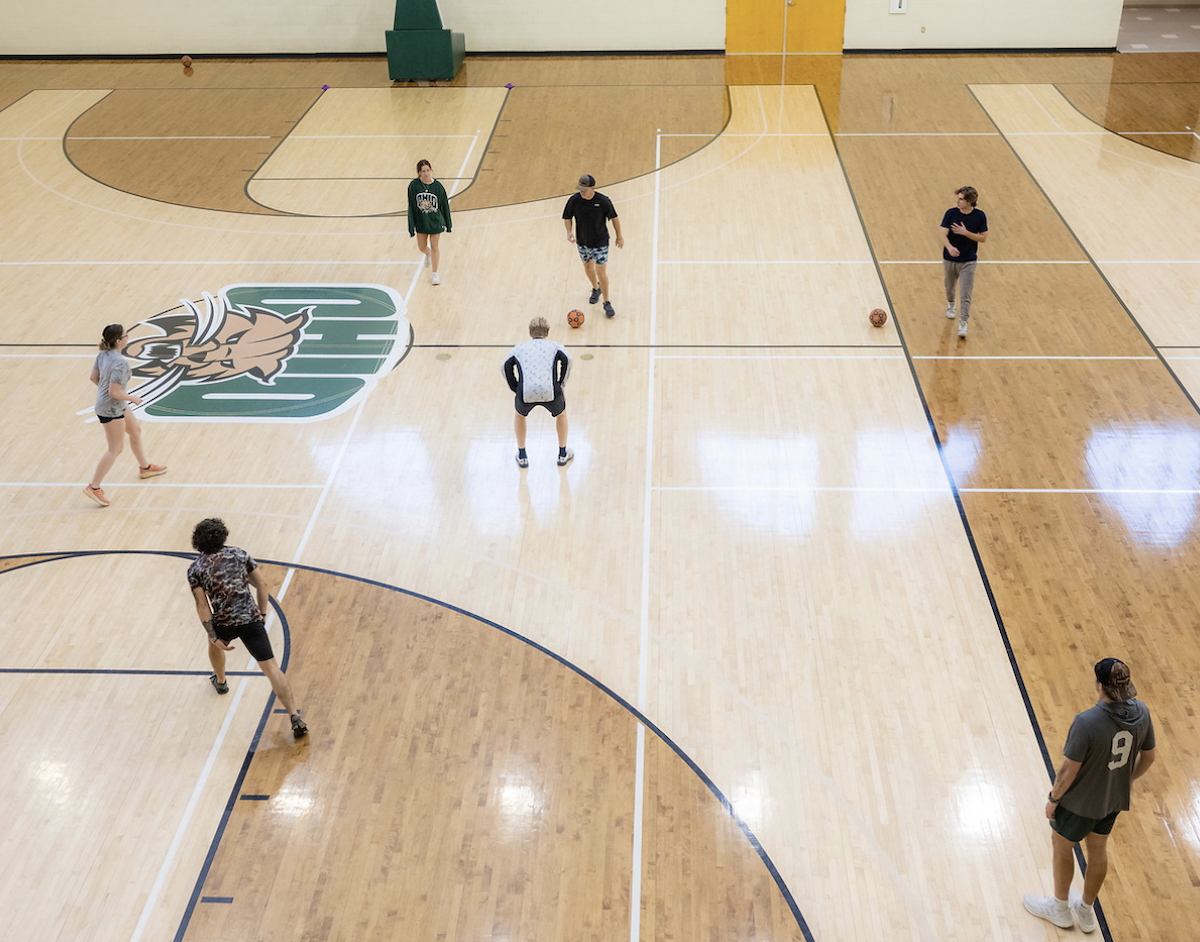 students in OHIO gym kicking a ball