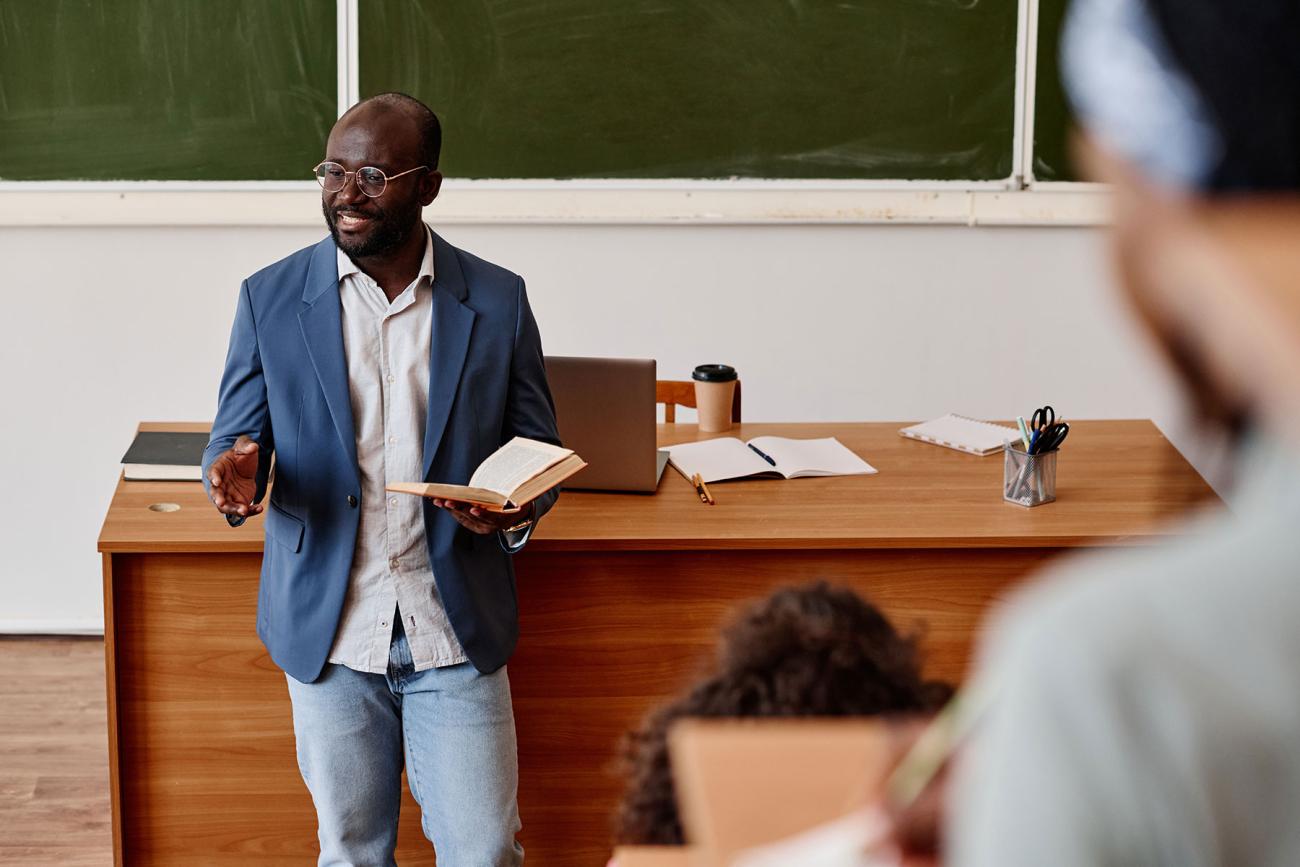 Professor gives a lecture in front of a classroom