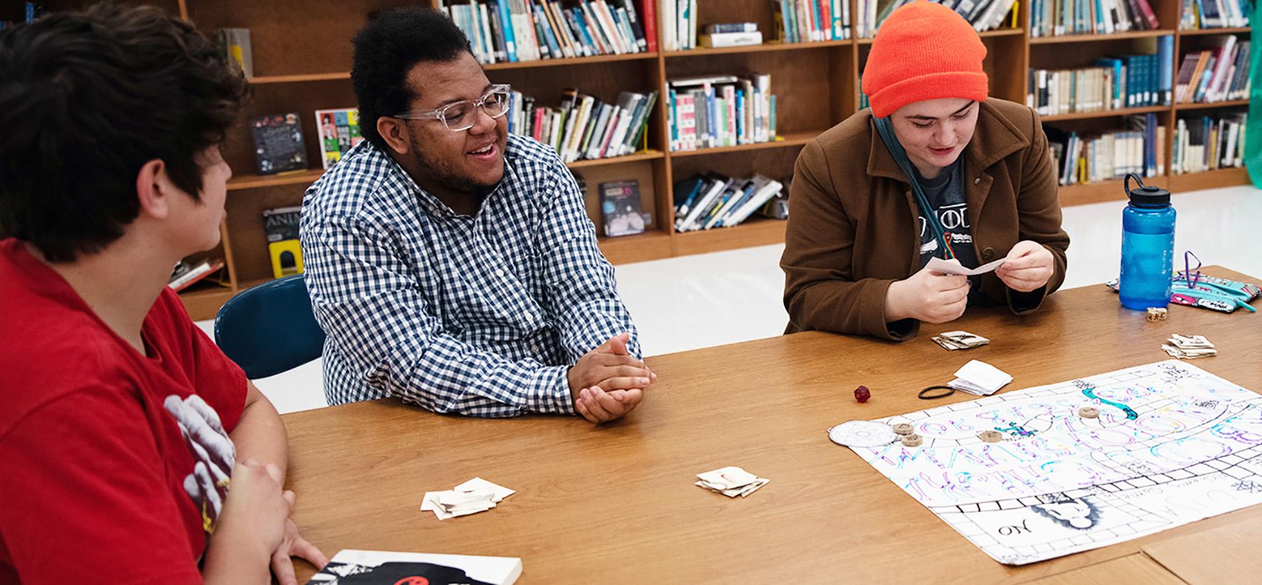 Students play a board game together