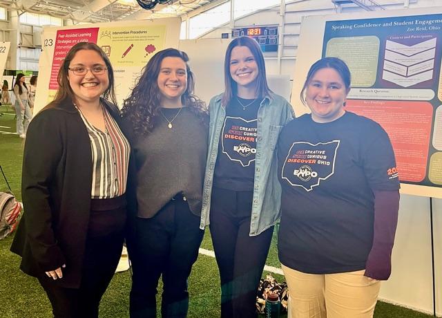 Connavino Scholars, Zoe, Laurel and Lauren, stand by their research presentation