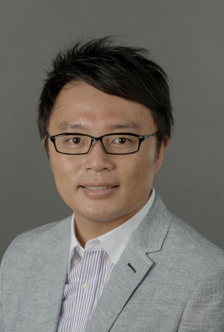 Headshot of Min Lun (Alan) Wu wearing glasses and a gray suit and white shirt.