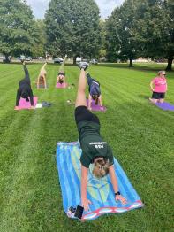 Faculty, Staff and Students doing yoga on the lawn behind Patton Hall
