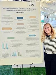 Honors Student Standing next to a display board with research results at the Expo 2025
