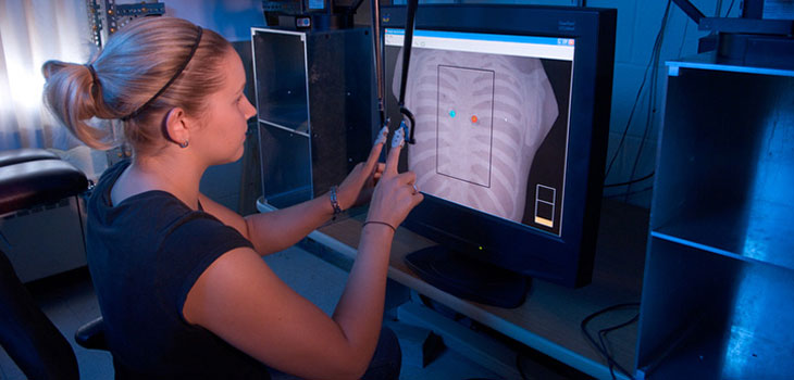 Female student analyzes a chest xray using modern computer interface