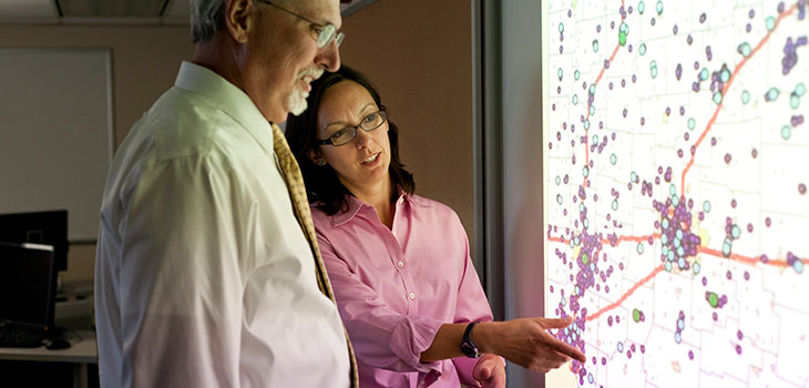 Two adults look at a map with frequency indicators