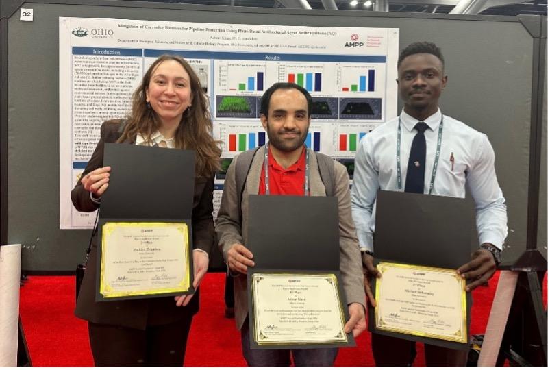 Three winners pose with their certificates from posters they created