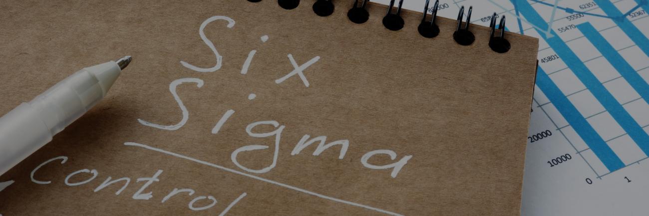 Six Sigma written on a notebook