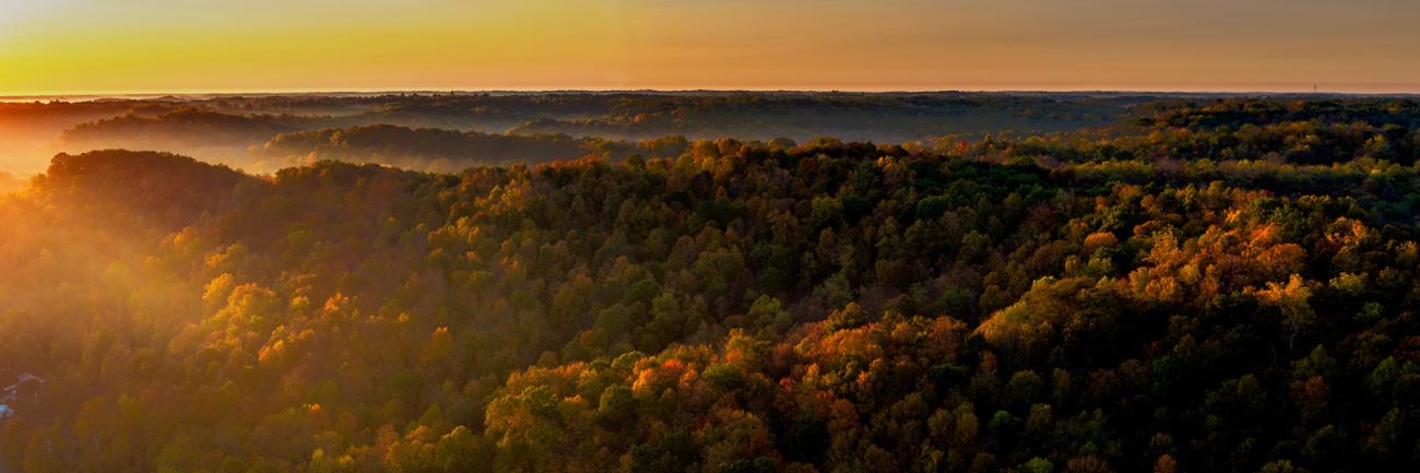 Sunrise cuts through fog in the Southeastern Ohio hills