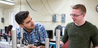 Mechanical engineering student working with a professor. 