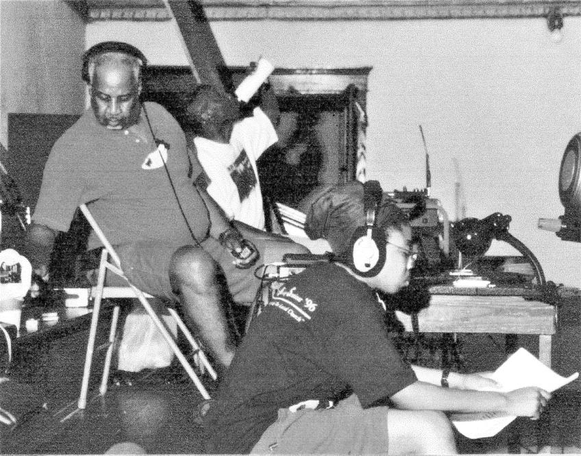 John Butler with Film student Traci Currie in foreground, the picture is old and frayed and black and white.