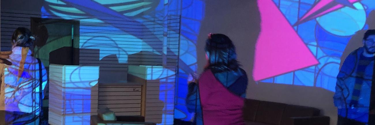 Digital Art + Technology students set up a live display with projectors, light.