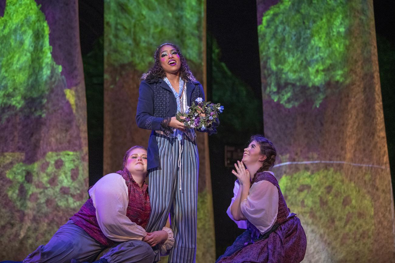 Three musical theater actors on stage singing