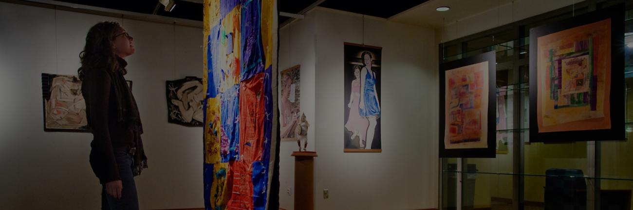 A student examines an art exhibit
