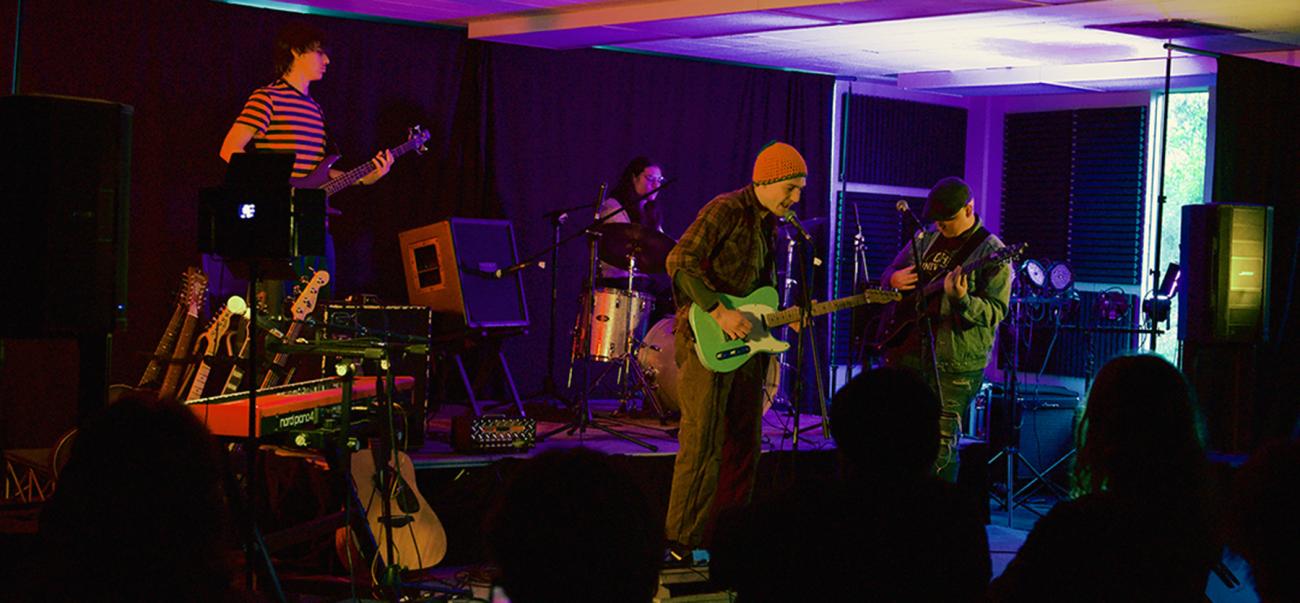Musicians rehearsing on stage.