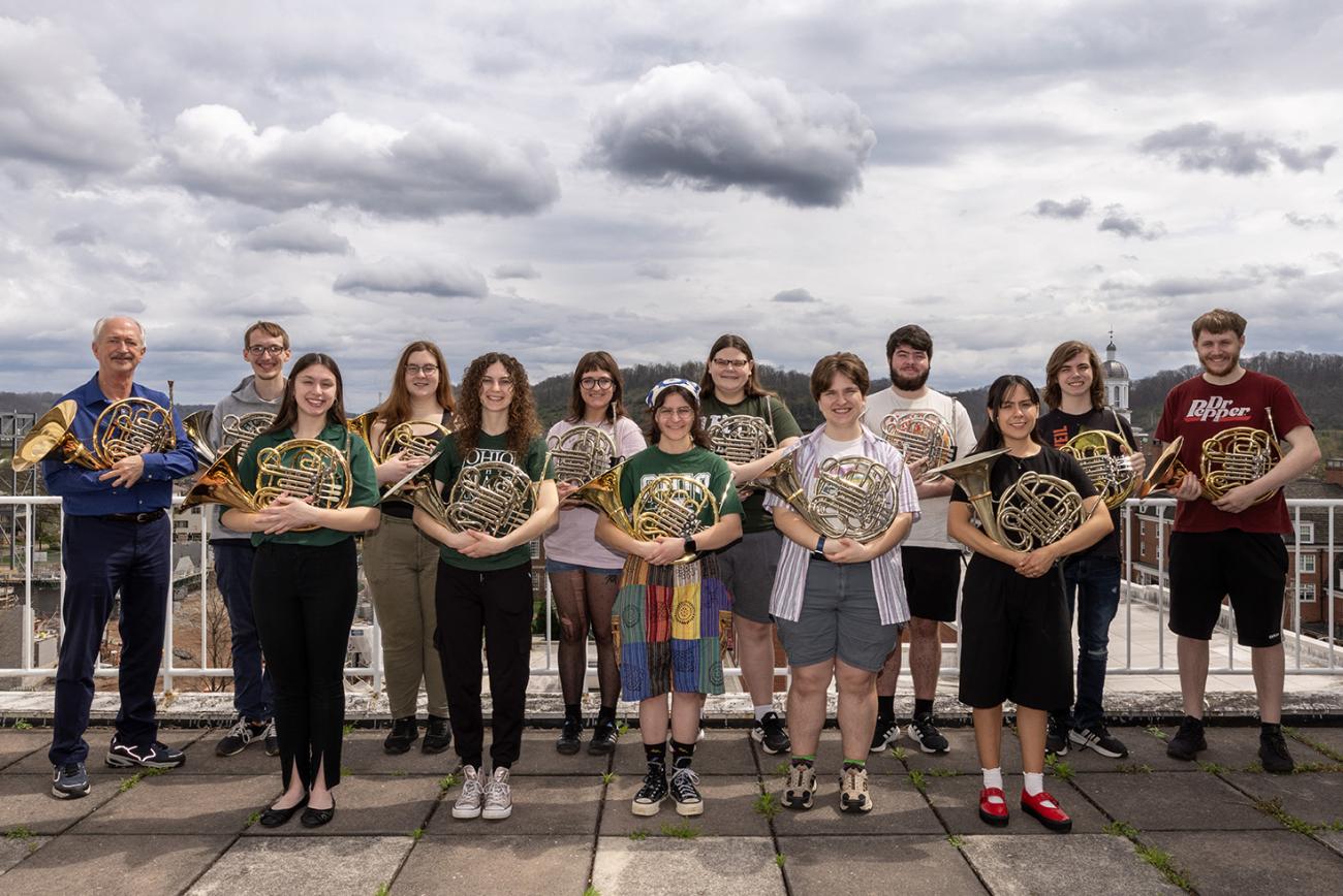 Students standing outside with horns