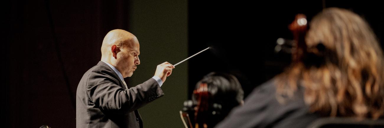 Ohio University professor conducts a symphony concert.