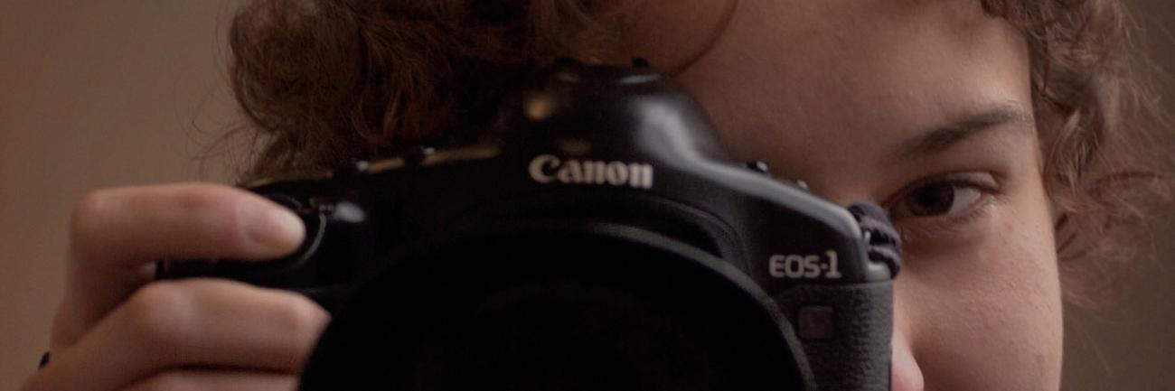 Women looking through a camera lens