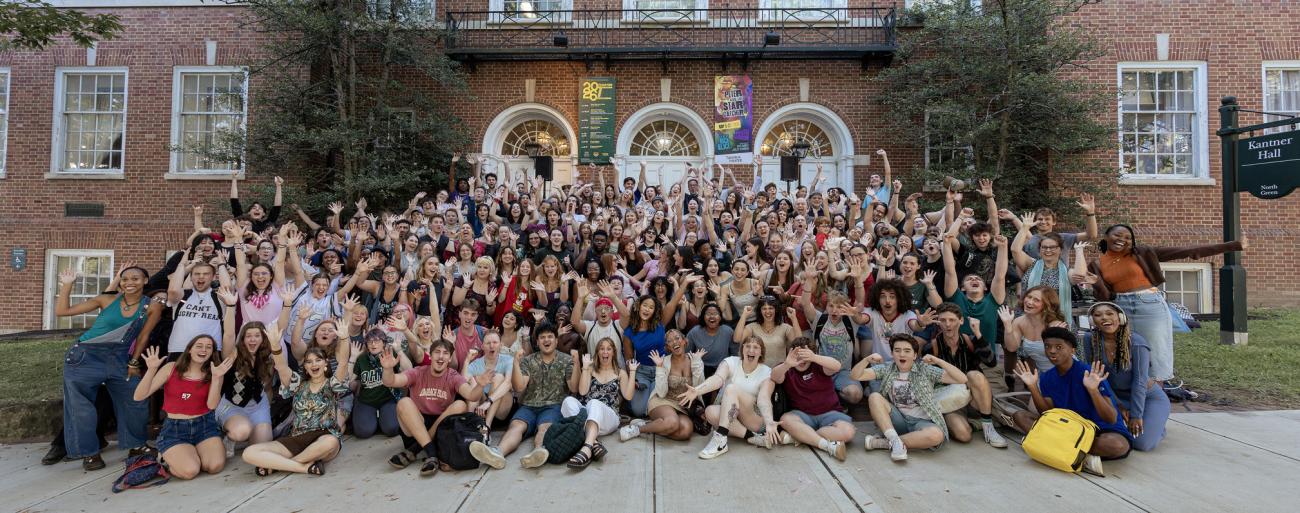 Ohio University theater students and faculty gathered in front of Kantner Hall, cheering and waving with arms raised.