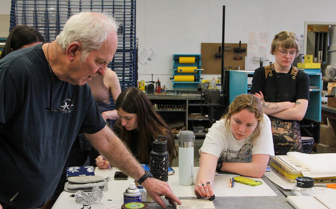 A visiting artist in the studio with students