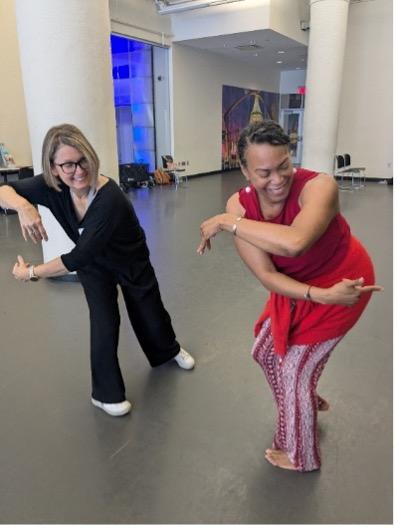 teacher teaching an adult student how to do a dance movement