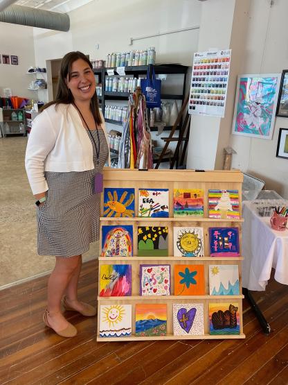 Jordan Mitri standing next to her project "Sunshine Studios: The Maker's Mark"