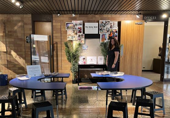 Emmie Lancaster standing by her project "The Unity Wall"