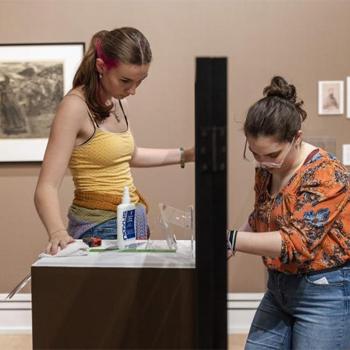 Two Ohio University students setting up a museum exhibit