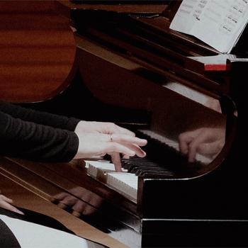Professor playing a grand piano at Ohio University