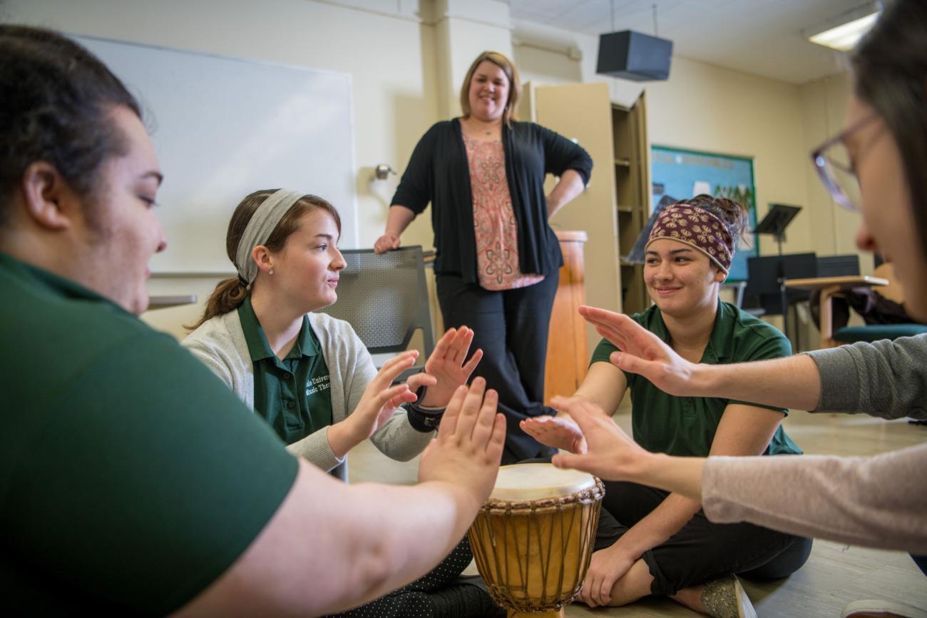 Music therapy majors practicing techniques in a group setting