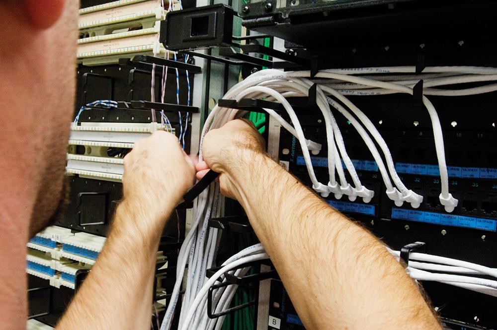 A person is adjusting network cables