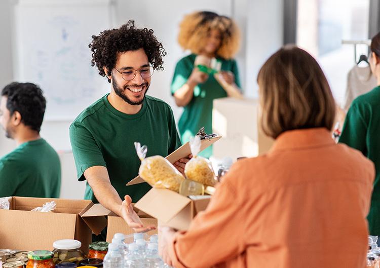 A man helping a woman with a box of goods