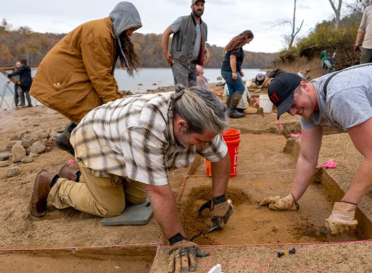 students excavating an area along a river in Virginia