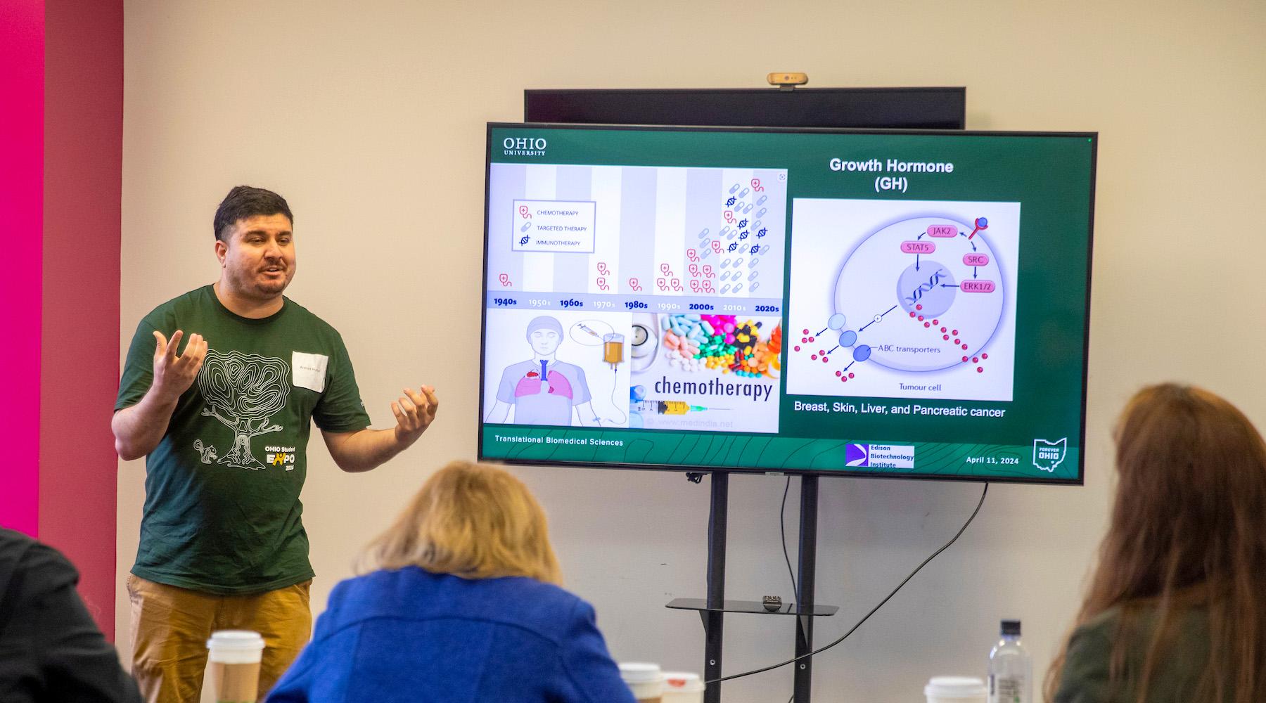 A man presenting to a room of people