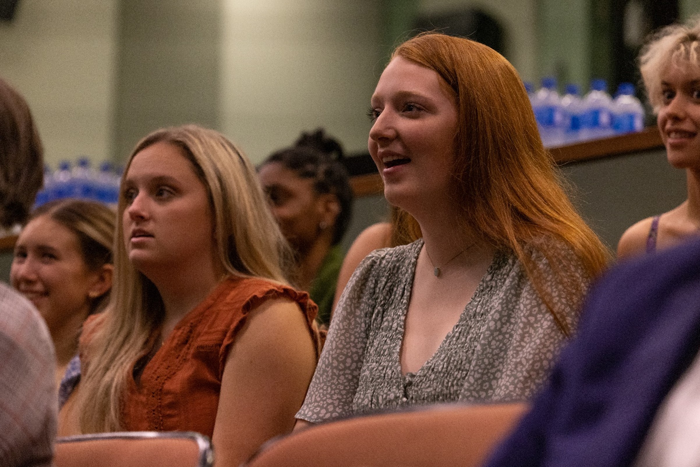 Picture of students in audience reacting to Gladys Bailin Stern speaking at presentation