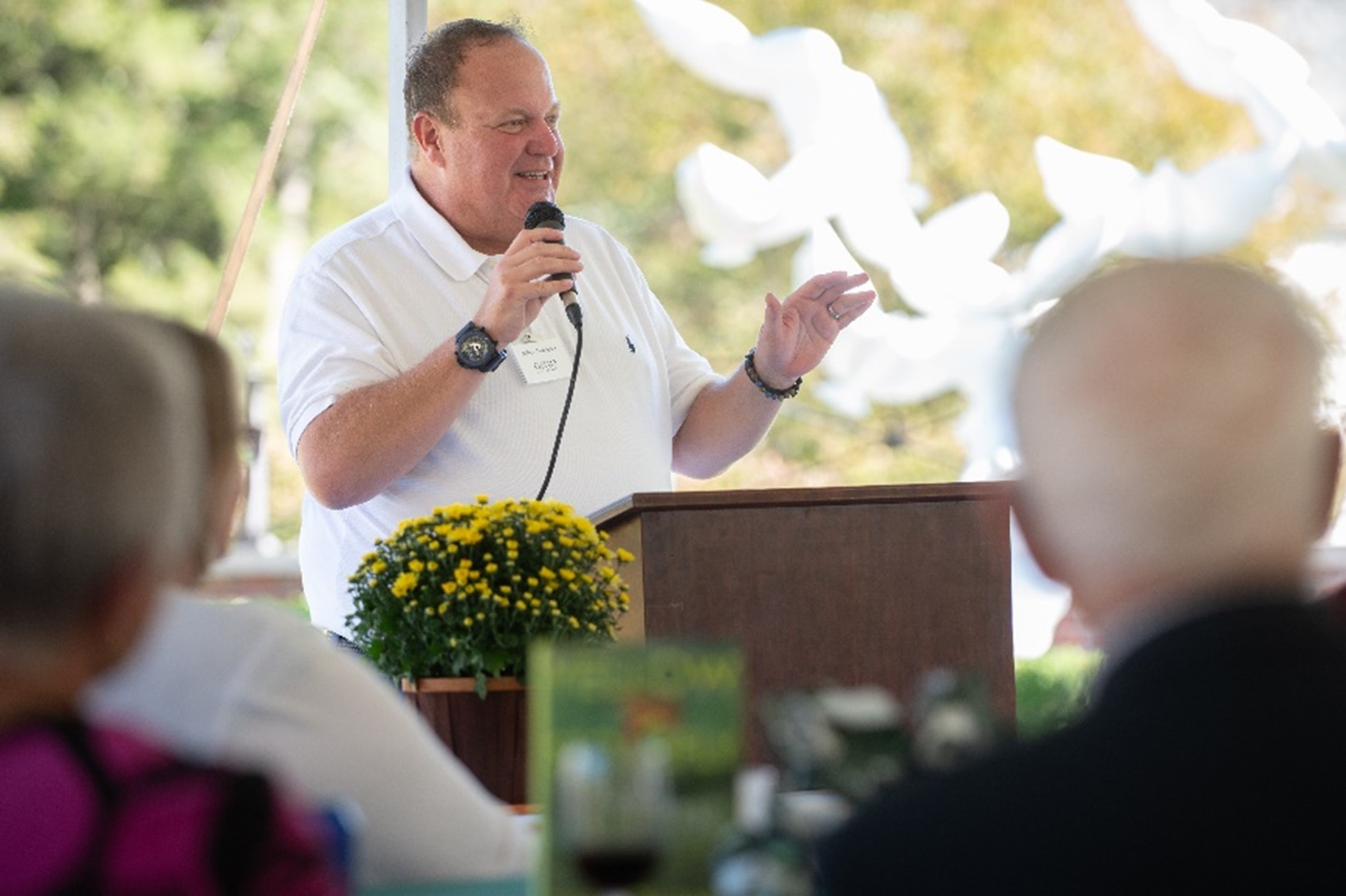 Photo of Jeffery Chaddock giving a speech at the Books, Gardens, and High Tea event