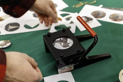 An OHIO student uses a button maker