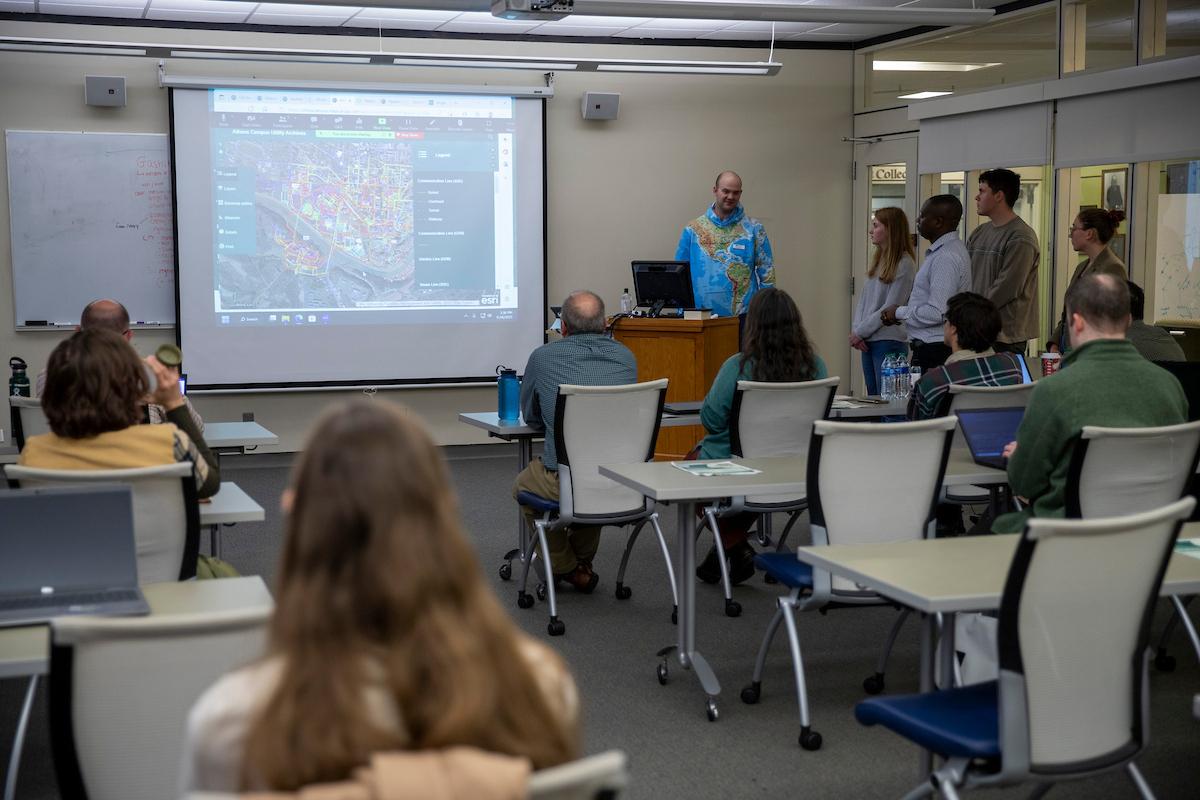 A lecturer presents research in the Alden Friends of the Libraries Room