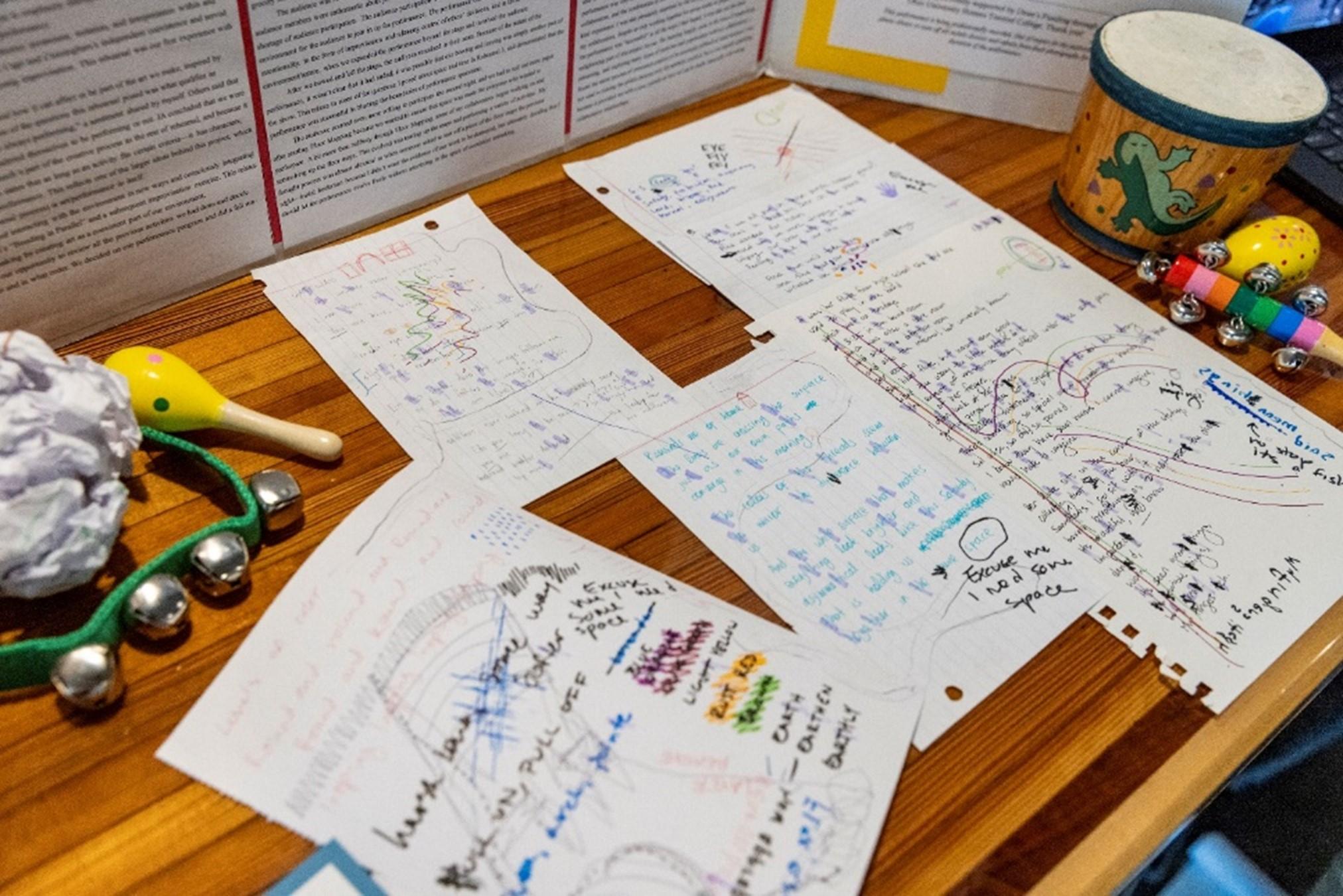 Photo of Allison Rollins' 2024 Expo display, featuring tambourine, handwritten music, and colorful notes