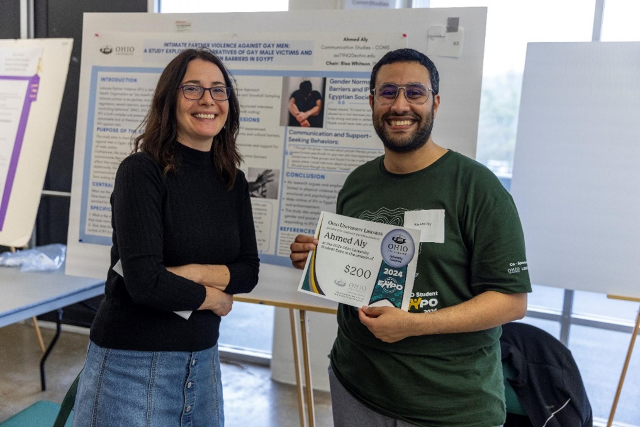 Photo of 2024 Expo awardee Ahmed Aly posing with library dean Janet Hulm