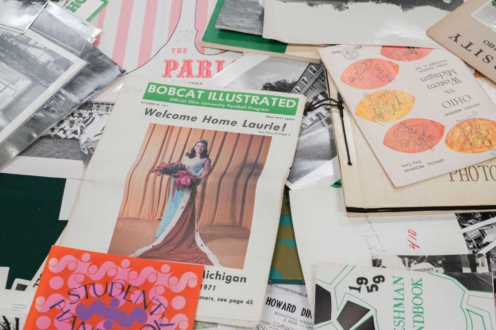 Various newspapers, magazines, and art on display for the Ohio University Homecoming Display at Alden Library