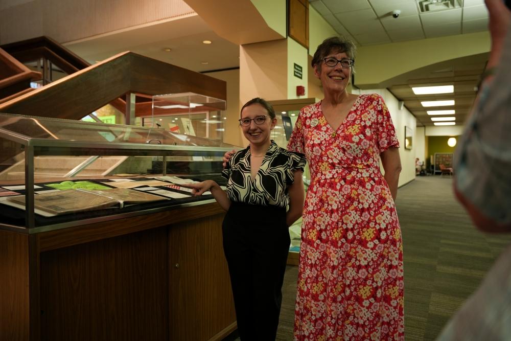 (From left) Alexis Reynolds, a junior studying English pre-law and world religions, and Professor Emerita Katherine Jellison pose for pictures in front of the “Venturing into Voting” exhibit. 