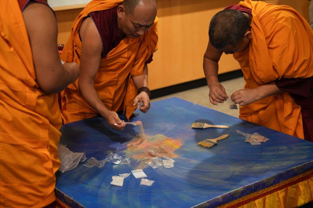 Tashi Kyil Monks package destroyed sand mandala for the audience after destruction ceremony