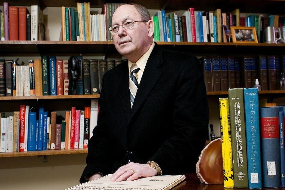 Richard D. Wetzel at a desk surrounded by books