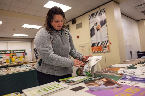 Alumni looking through yearbooks