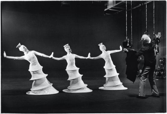 Black and white image of three dancers in costume
